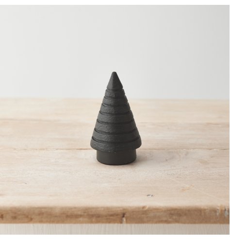 A sculptural tree carved from wood with ridged detailing and a minimal aesthetic. A must have seasonal decoration. 