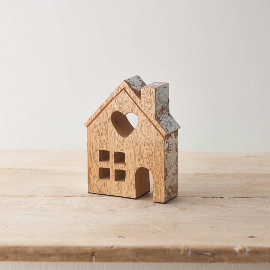 A rustic wooden house ornament with a raw finish. A stylish interior accessory with charming crafted details 