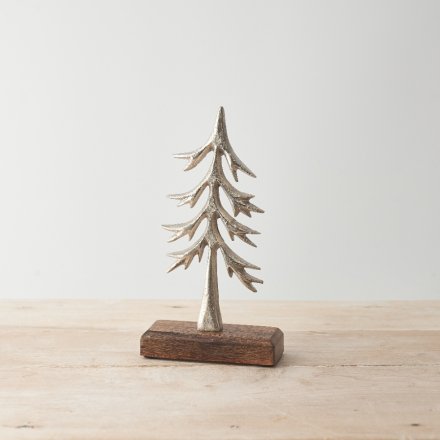 A stylish silver tree ornament with a chunky base made from natural mango wood. 