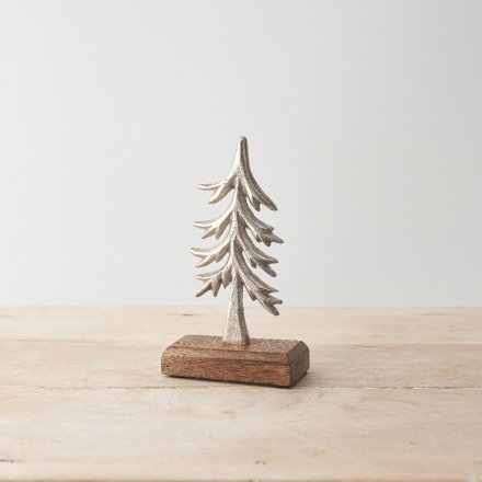 A stylish metal tree ornament with a hammered finish and chunky wooden base. 