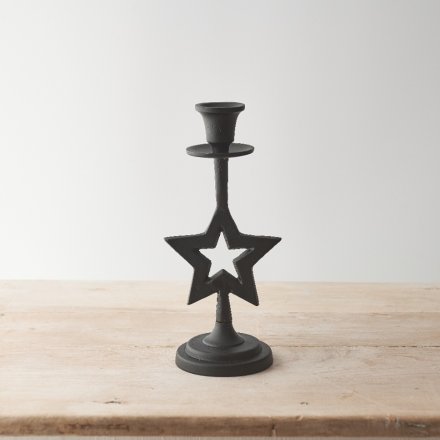 A contemporary metal candlestick with star detail and black finish. 
