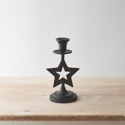 A unique metal candle stick holder with a star detail and black hammered surface. 