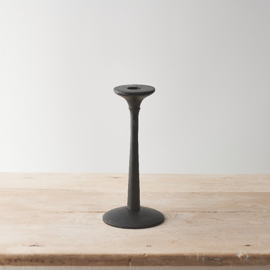 A contemporary metal candlestick stand. A simple and elegant design with a black finish. 