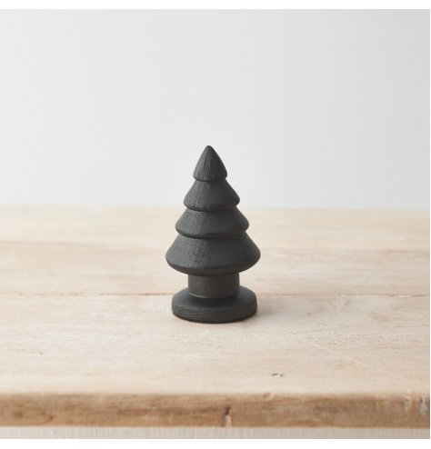 A statement seasonal decoration for the home. Crafted from natural mango wood with a chunky design and black paint.