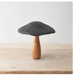 A stylish mushroom ornament crafted from mango wood and hammered metal. 