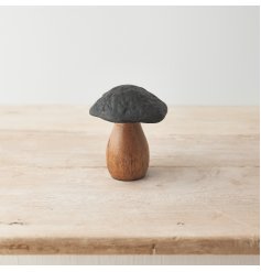 A unique mushroom ornament in dark earthy colours. Made from mango wood and hammered metal with a black finish. 