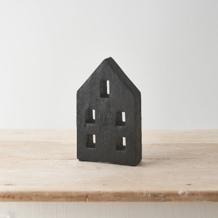 A contemporary carved wooden house made from natural mango wood. A chunky design with a black painted finish. 