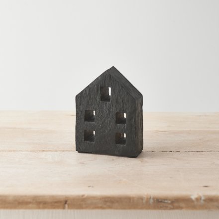 A chunky wooden house with a natural wood grain and black painted finish. 