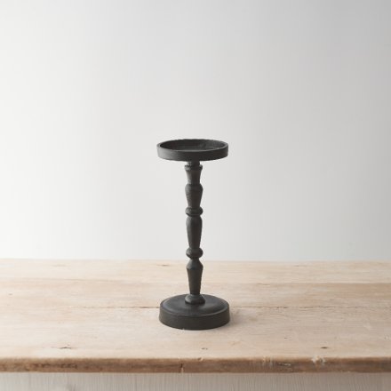 An elegant tall candle holder made from raw aluminium with a matt black coating. 