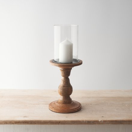 Country style pillar candle holder on a wooden stand