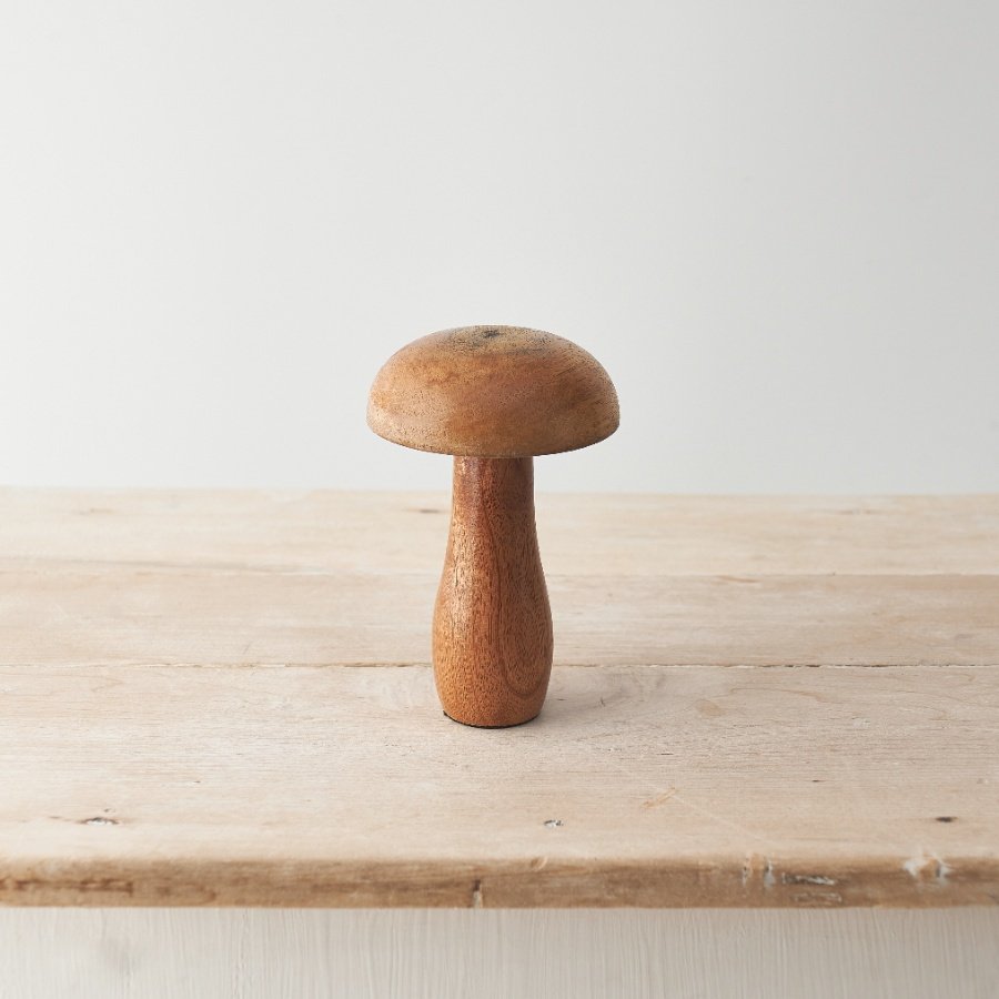 A contemporary mushroom ornament made from natural mango wood. 