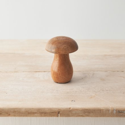 A stylish wooden mushroom ornament with a raw, natural finish. 