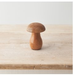 A chunky mushroom ornament crafted from natural mango wood. An on trend sculptural decoration for the home. 