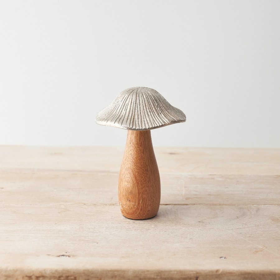 A natural mushroom ornament made from mango wood and hammered metal. With texture and character 