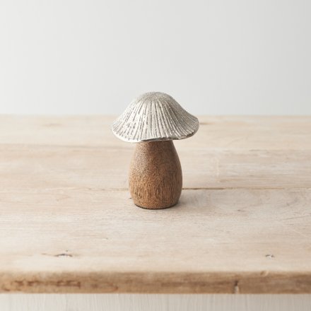 A rustic mushroom ornament. Beautifully detailed with a raw wooden base and hammered silver cap. 