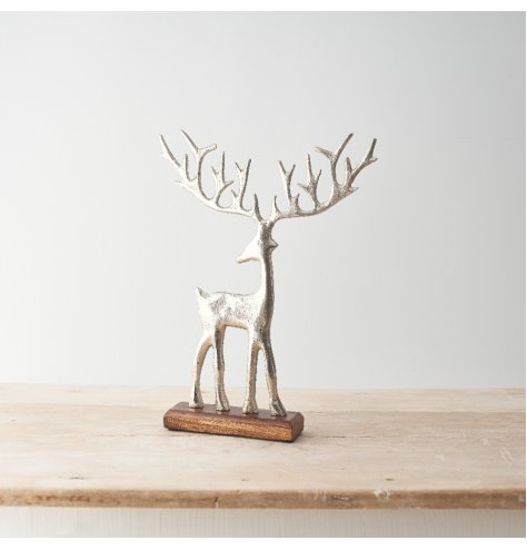 Large reindeer in silver stood on a wood base