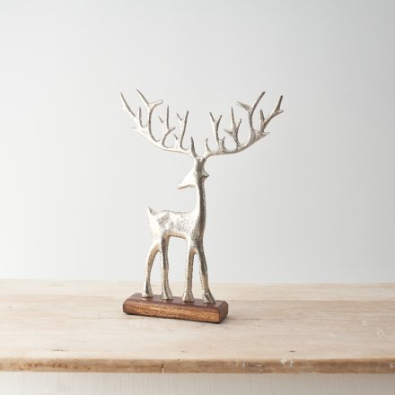 Silver reindeer standing on a wooden base
