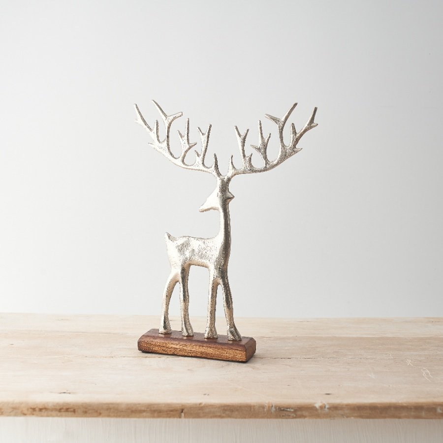 Reindeer in brushed silver on a wooden stand with large antlers