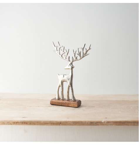 Reindeer in a sculptural finish standing on a wooden base