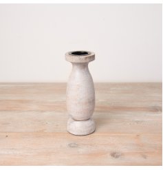 A rustic wooden pillar candle holder with a white washed finish. 