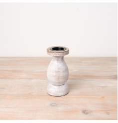 A rustic wooden pillar candle holder with a white washed finish. 