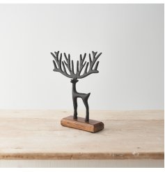 A decorative reindeer on a contrasting wooden base featuring a stylish black finish and sculptural antlers.