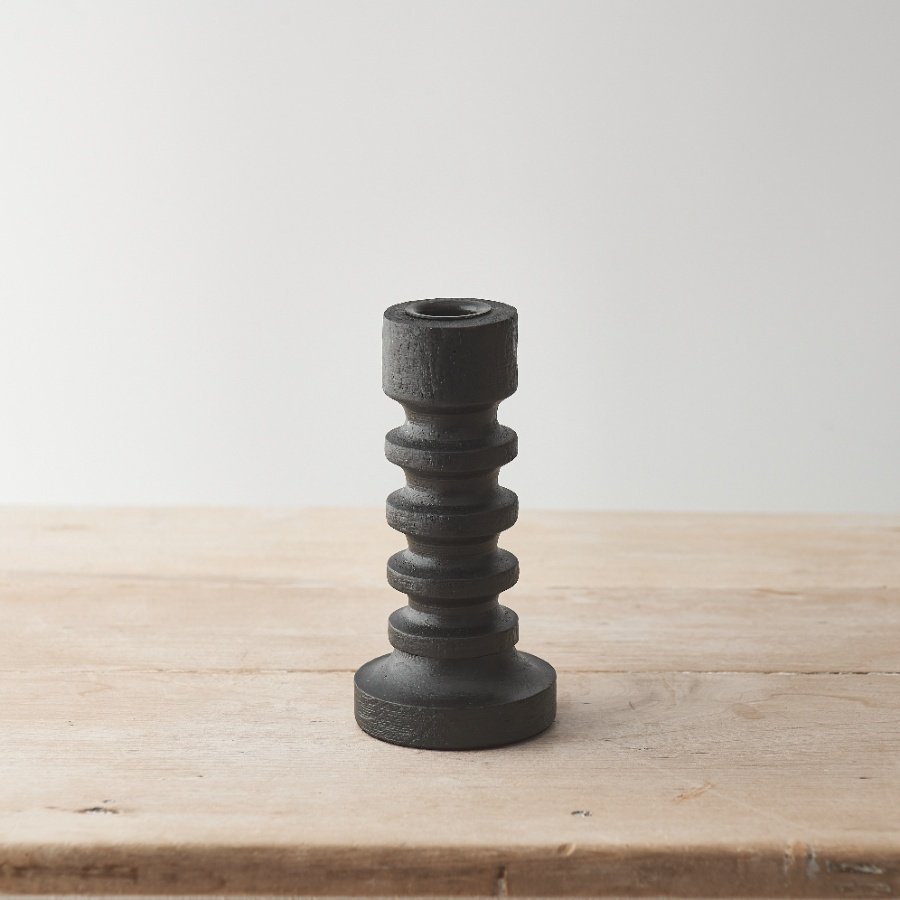 A black painted finish wooden candle pillar with a stylish minimalist design.
