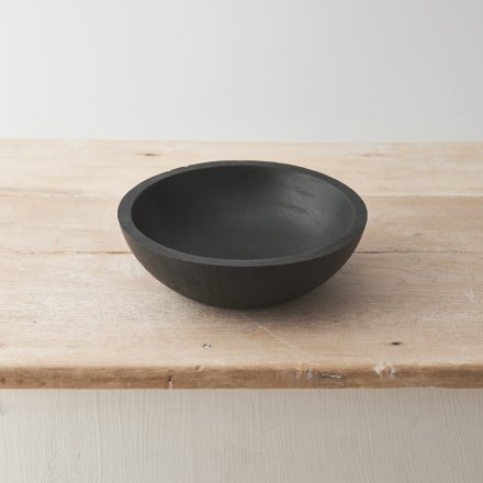 A contemporary black bowl crafted from natural mango wood. 