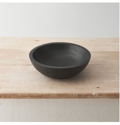 A contemporary black bowl crafted from natural mango wood. 