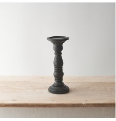 A stylish wooden candle stand with a contemporary sculptural design and chic black painted finish. 
