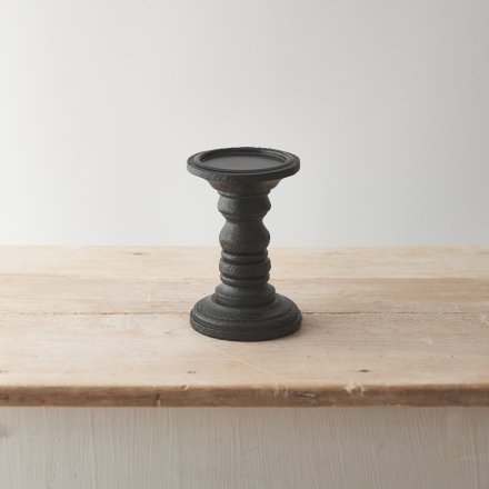 A wooden candle stand with black finish, sleek lines and a modern minimalist design. 