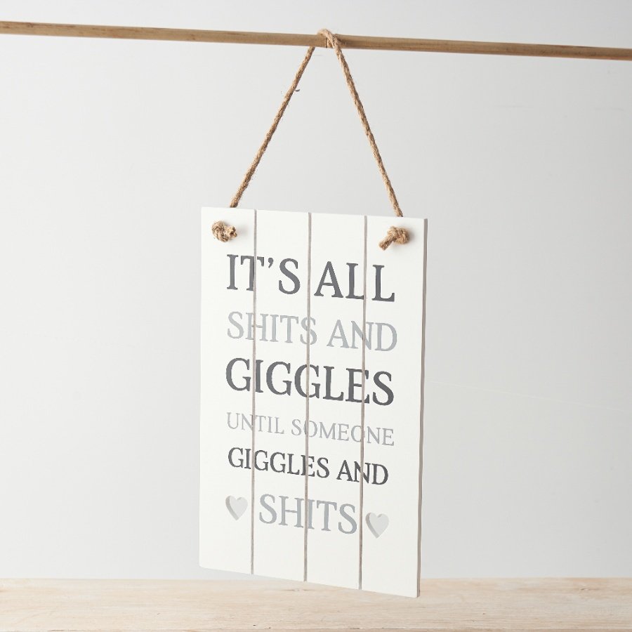 A slatted sign with rope hanger, heart detail and humorous "it's all shits & giggles until someone giggles & shits" text