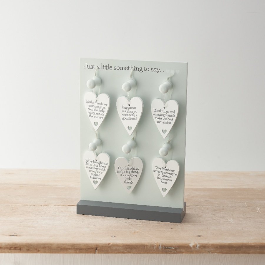 An assortment of 6 simple white and silver heart signs, decorated with friendship quote wording.