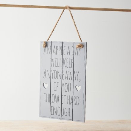 A small wooden plaque printed with a comical scripted text decal