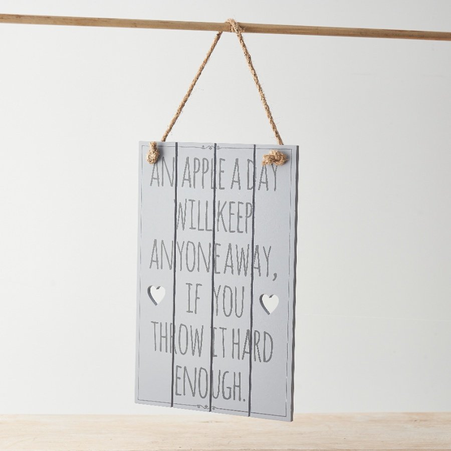 A wooden hanging sign with fun "an apple a day will keep anyone away if you throw them hard enough" message. 