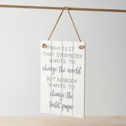A decorative wooden sign with slatted design and humorous quote about changing toilet paper!