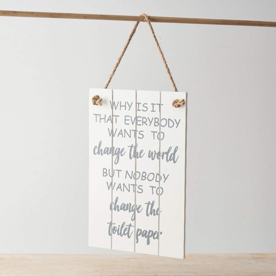 A decorative wooden sign with panelled design and funny quote about changing toilet paper!