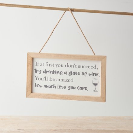 A framed hanging sign decoration with a jute hanger and fun message about wine. 