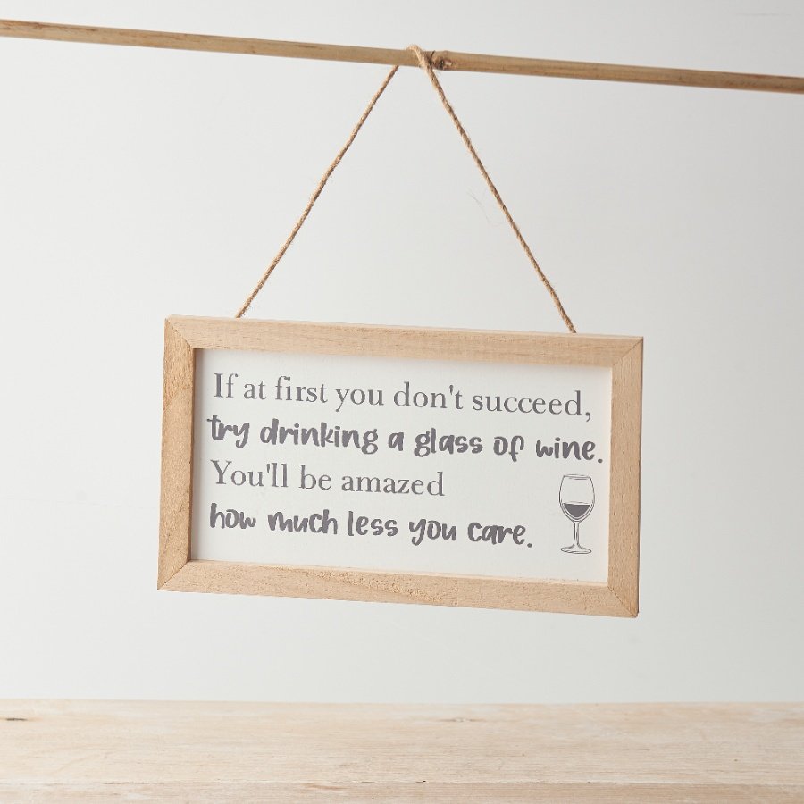 A hanging sign decoration with chunky framed design and humorous quote about a glass of wine!