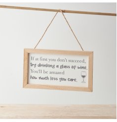 A hanging sign with framed design, jute hanger and fun message about wine!