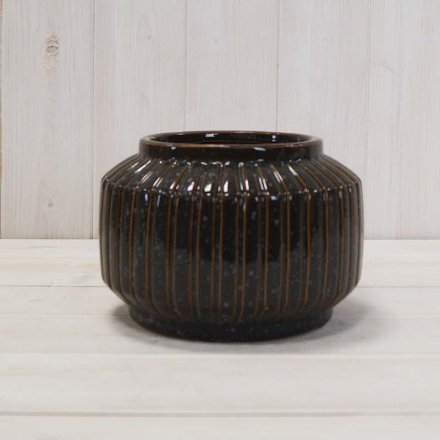 A stylish pot with a stripe design and a glossy finish. An on trend decorative vessel or planter for the home. 