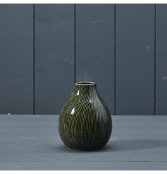 A stylish ceramic vase with a beautiful earthy green glaze and a stripy swirl design. 
