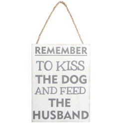 A cheeky sign with "remember to kiss the dog and feed the husband" text on a distressed background with rope hanger. 