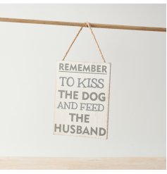 A cheeky sign with "remember to kiss the dog and feed the husband" text on a distressed background with rope hanger. 