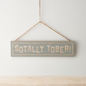 A wooden hanging sign with long hanger and fun "sotally tober" text on a grey background. 