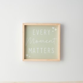 A sweet framed sign with  "every moment matters" text and heart details on a stylish sage green background. 