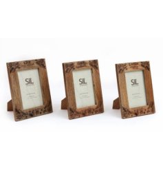 3 assorted wooden frames in a floral design with quotes displayed at the top. 