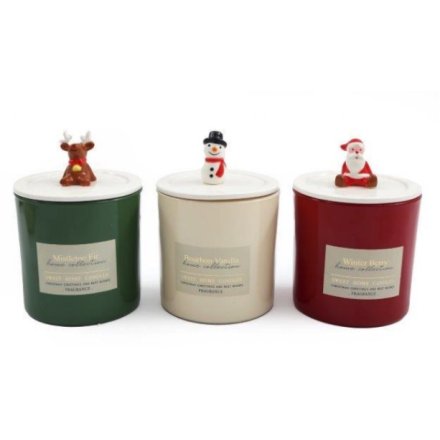 An assortment of 3 scented candles each with a character topper lid