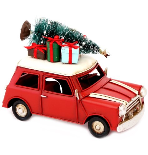 Red festive car ornament with intricate gifts and green frosted tree. 