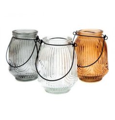 An assortment of 3 small glass lanterns, each with a stylish arch patterned 3d finish and metal handle. 